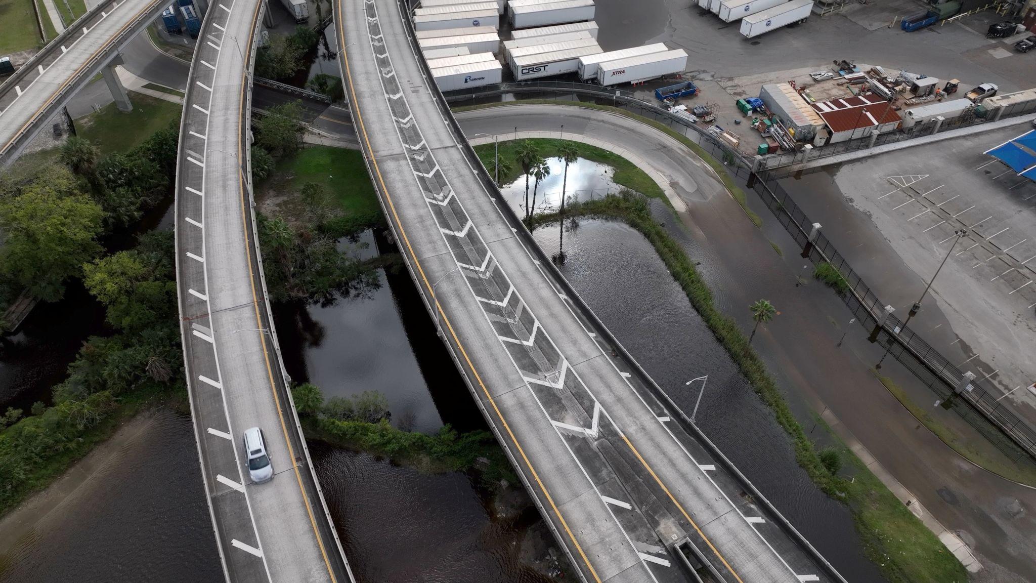 Aerial view of flooded highway infrastructure, climate risk to industrial assets
